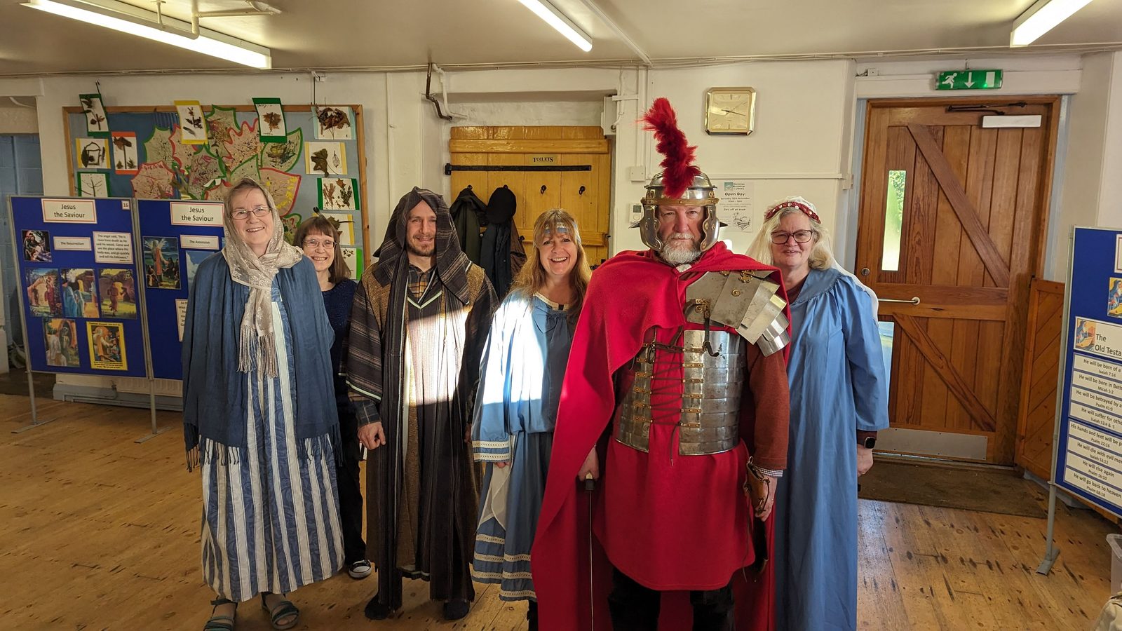 Costumed characters from the Bible Exhibition standing in front of the display boards