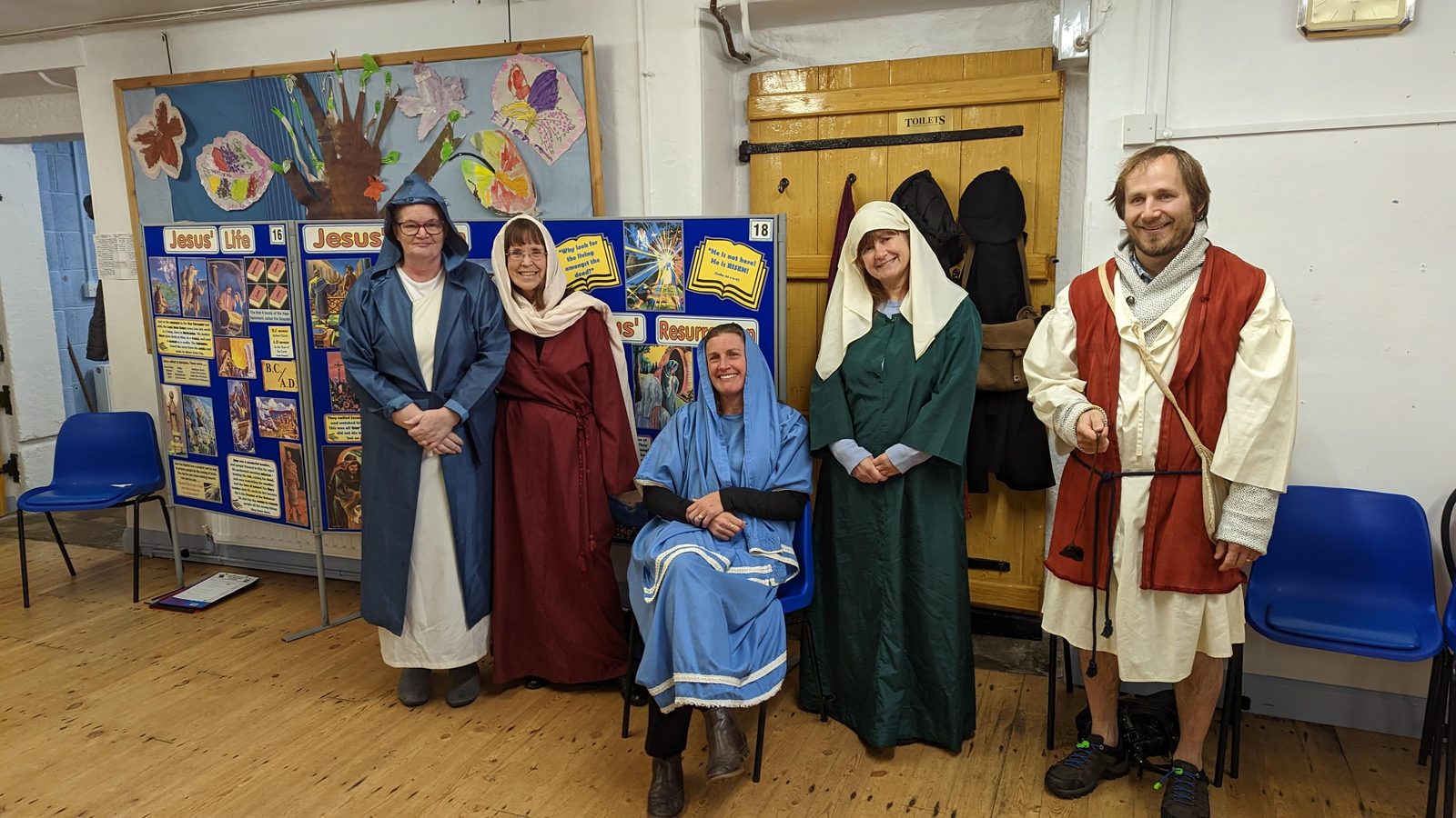 Costumed characters from the Bible Exhibition, including a Roman soldier, standing in front of the display boards